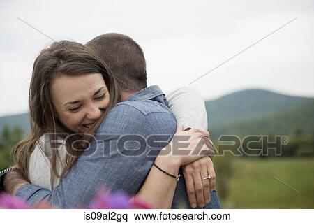 Stock Photography - Couple embracing, outdoors. Fotosearch
