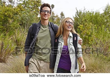 Couple enjoying walk in forest View Large Photo Image Stock Image - Couple enjoying walk in forest. Fotosearch