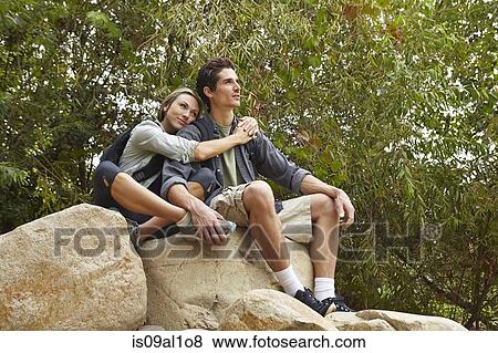 Couple hugging on rock View Large Photo Image Stock Photo - Couple hugging on rock. Fotosearch