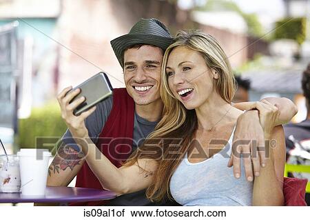 Couple taking selfie at cafe View Large Photo Image Stock Image - Couple taking selfie at cafe. Fotosearch
