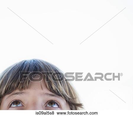 Stock Photo - Cropped close up portrait of girl looking upward. Fotosearch