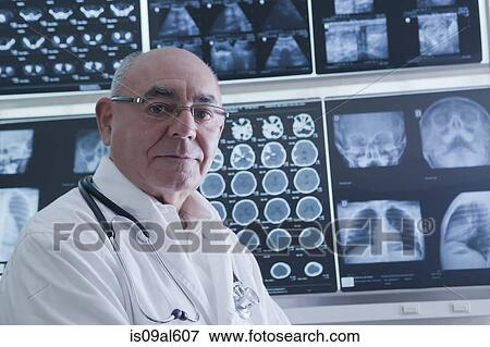 Doctor analysing scan results View Large Photo Image Stock Photo - Doctor analysing scan results. Fotosearch