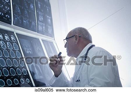 Doctor analysing scan results View Large Photo Image Stock Photography - Doctor analysing scan results. Fotosearch