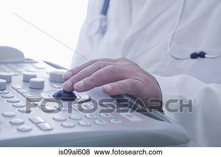 Doctor operating ultrasound scanner View Large Photo Image Stock Photo - Doctor operating ultrasound scanner. Fotosearch