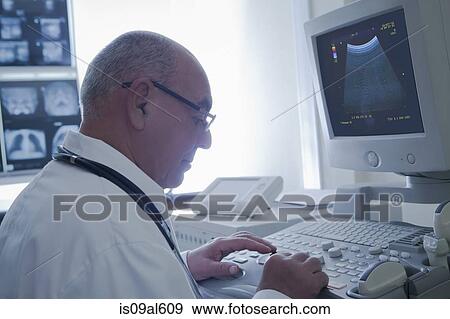 Doctor operating ultrasound scanner View Large Photo Image Stock Photo - Doctor operating ultrasound scanner. Fotosearch