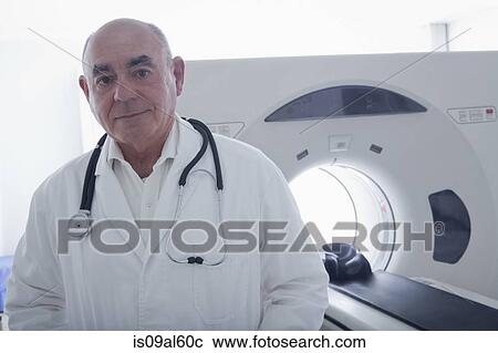 Doctor standing beside CT scanner View Large Photo Image Stock Image - Doctor standing beside CT scanner. Fotosearch