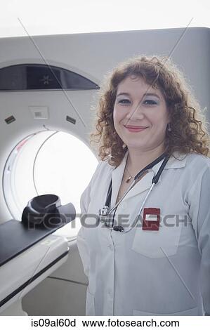 Doctor standing beside CT scanner View Large Photo Image Stock Image - Doctor standing beside CT scanner. Fotosearch