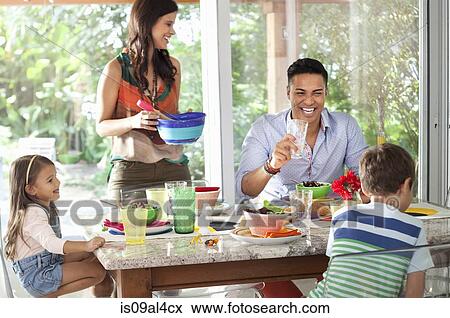 Stock Photo - Family at dining table. Fotosearch