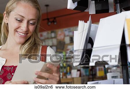 Female customer looking at greetings card in stationery shop View Large Photo Image Stock Photograph - Female customer looking at greetings card in stationery shop. Fotosearch