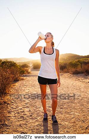 Female jogger drinking from water bottle, Poway, CA, USA View Large Photo Image Stock Photo - Female jogger drinking from water bottle, Poway, CA, USA. Fotosearch