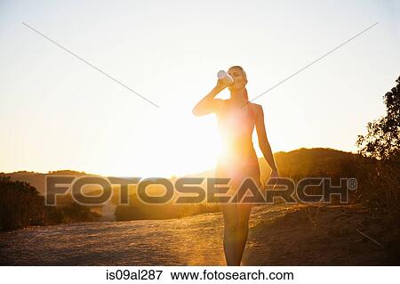 Female jogger drinking in sunlight, Poway, CA, USA View Large Photo Image Stock Photo - Female jogger drinking in sunlight, Poway, CA, USA. Fotosearch