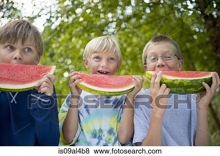 Friends eating watermelon in garden View Large Photo Image Stock Photo - Friends eating watermelon in garden. Fotosearch