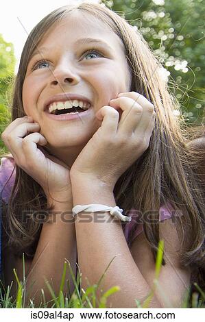 Stock Photography - Girl lying on grass. Fotosearch