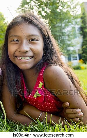Stock Photography - Girl lying on grass. Fotosearch