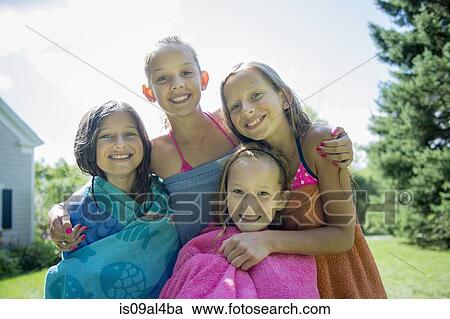 Stock Image - Girls in swimming costume wrapped in towels. Fotosearch