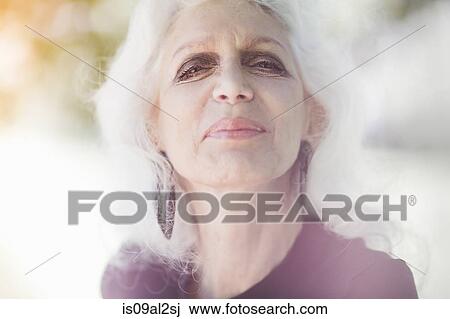 Stock Image - Gray haired woman smiling with confidence. Fotosearch