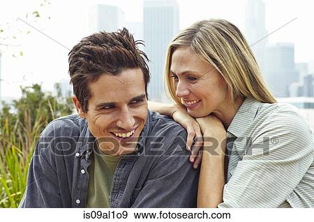 Happy couple in park by city View Large Photo Image Stock Photo - Happy couple in park by city. Fotosearch
