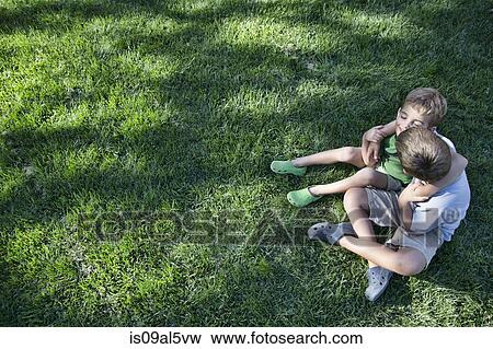 High angle view of two brothers with arms around each other in garden View Large Photo Image Stock Photo - High angle view of two brothers with arms around each other in garden. Fotosearch