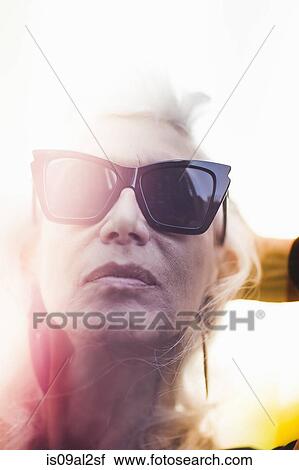 Stock Image - Hip senior woman wearing sunglasses. Fotosearch