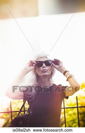 Stock Image - Hip senior woman wearing sunglasses. Fotosearch