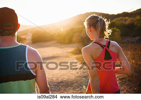 Picture - Joggers walking on sunlit path, Poway, CA, USA. Fotosearch