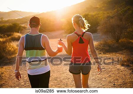Stock Photography - Joggers walking on sunlit path, Poway, CA, USA. Fotosearch