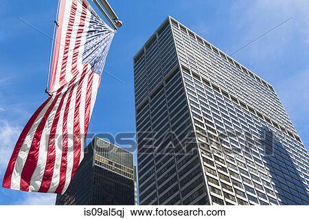 Low angled view of skyscrapers and American flag in financial district, Manhattan, New York, USA View Large Photo Image Stock Image - Low angled view of skyscrapers and American flag in financial district, Manhattan, New York, USA. Fotosearch