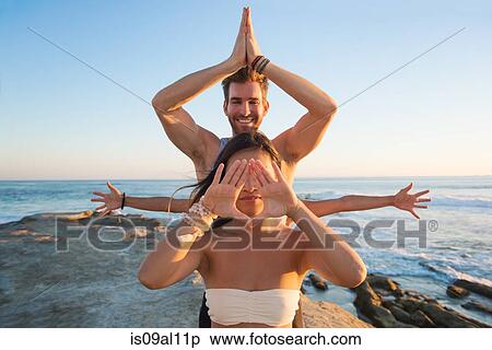Man and woman in yoga poses, Windansea beach, La Jolla, California View Large Photo Image Stock Photography - Man and woman in yoga poses, Windansea beach, La Jolla, California. Fotosearch