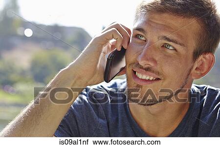 Stock Image - Man using smartphone. Fotosearch