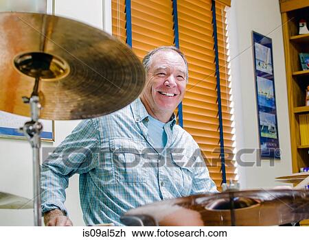 Mature man playing drums at home View Large Photo Image Stock Image - Mature man playing drums at home. Fotosearch