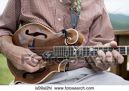 Mature man playing mandolin, mid section, close-up View Large Photo Image Stock Image - Mature man playing mandolin, mid section, close-up. Fotosearch