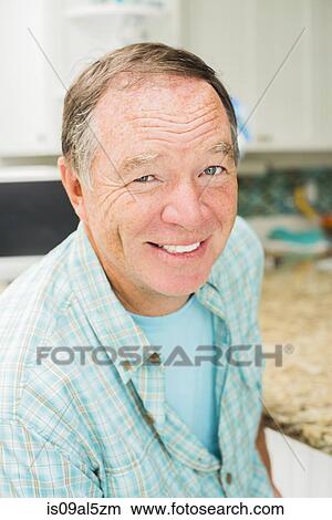 Mature man sitting in kitchen View Large Photo Image Picture - Mature man sitting in kitchen. Fotosearch