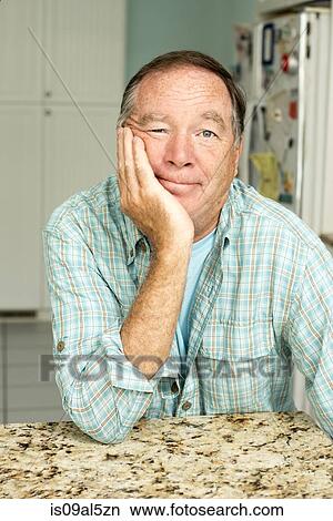 Mature man sitting in kitchen View Large Photo Image Picture - Mature man sitting in kitchen. Fotosearch