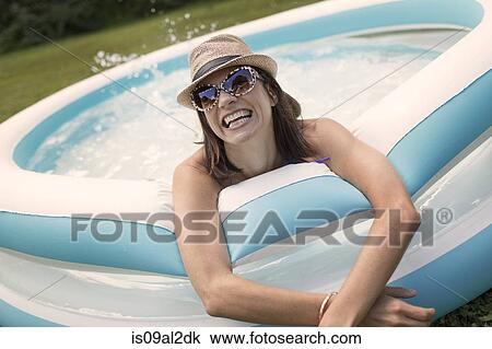 Mature woman in paddling pool, splashing water View Large Photo Image Stock Image - Mature woman in paddling pool, splashing water. Fotosearch