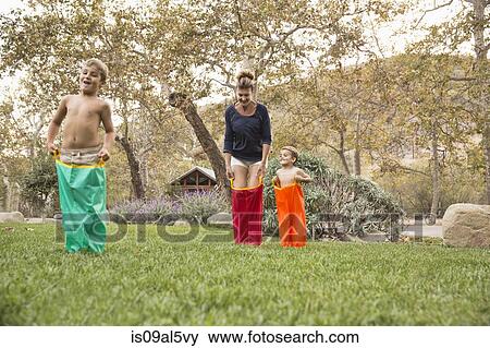 Mother and two sons having a sack race, County Park, Los Angeles, California, USA View Large Photo Image Stock Photo - Mother and two sons having a sack race, County Park, Los Angeles, California, USA. Fotosearch