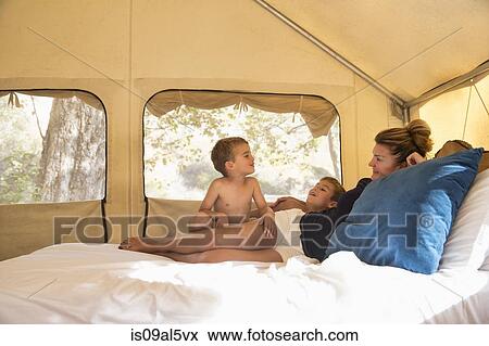Mother and two sons reclining on tent bed whilst glamping, County Park, Los Angeles, California, USA View Large Photo Image Stock Photo - Mother and two sons reclining on tent bed whilst glamping, County Park, Los Angeles, California, USA. Fotosearch