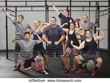 Portrait of eight crossfit colleagues flexing muscles in gym View Large Photo Image Picture - Portrait of eight crossfit colleagues flexing muscles in gym. Fotosearch