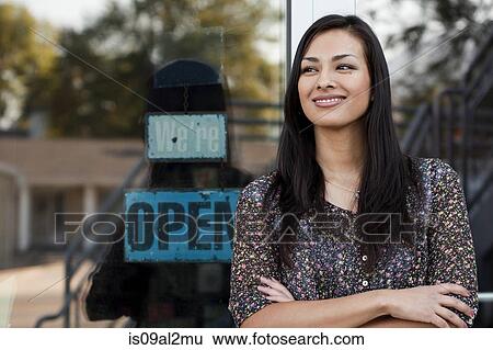 Stock Photograph - Portrait of sales assistant outside shop window. Fotosearch