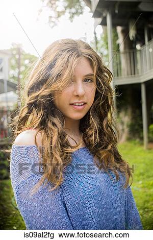 Stock Image - Portrait of teenager girl, outdoors. Fotosearch