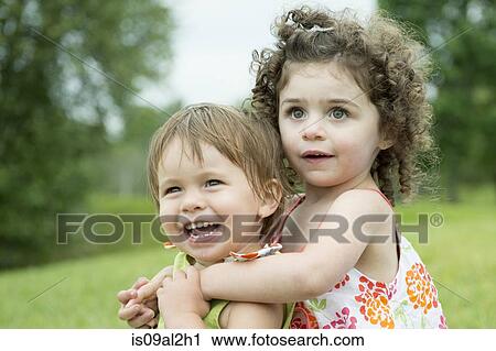 Stock Image - Portrait of two toddlers, playing. Fotosearch