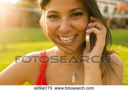 Portrait of young woman chatting on smartphone View Large Photo Image Stock Image - Portrait of young woman chatting on smartphone. Fotosearch