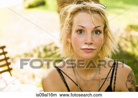 Picture - Portrait of young woman in park with coffee mustache. Fotosearch