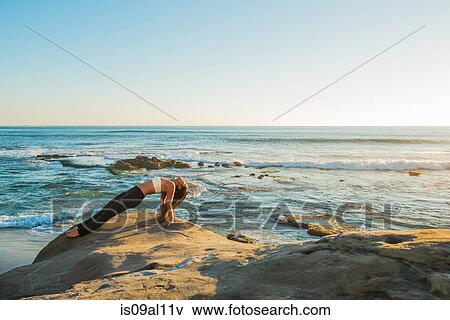 Stock Photo - Reverse plank pose, Windansea beach, La Jolla, California. Fotosearch