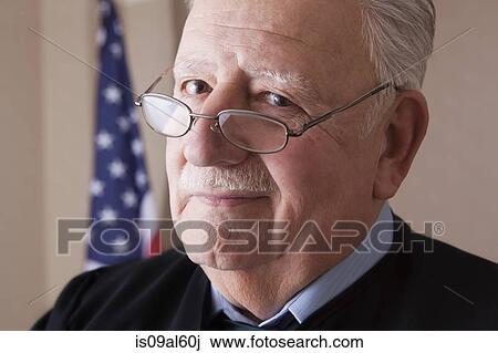 Stock Image - Senior judge looking over glasses. Fotosearch