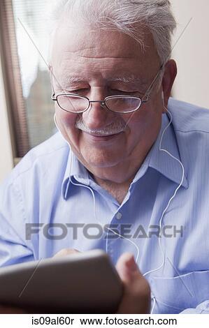 Senior man reading digital tablet View Large Photo Image Stock Photography - Senior man reading digital tablet. Fotosearch