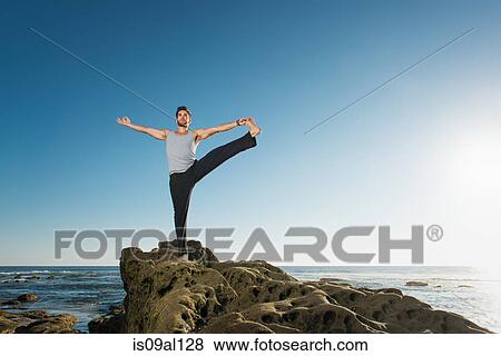 Standing Big Toe pose - Utthita Hasta Padangusthasana, Windansea beach, La Jolla, California View Large Photo Image Stock Photo - Standing Big Toe pose - Utthita Hasta Padangusthasana, Windansea beach, La Jolla, California. Fotosearch
