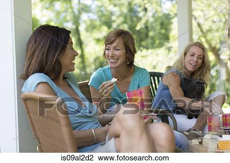 Three mature woman eating and drinking together View Large Photo Image Stock Image - Three mature woman eating and drinking together. Fotosearch