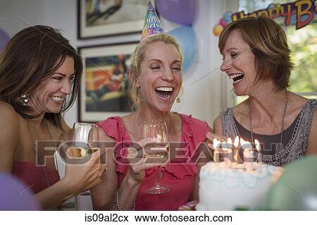 Three mature women at birthday party, laughing View Large Photo Image Stock Photo - Three mature women at birthday party, laughing. Fotosearch