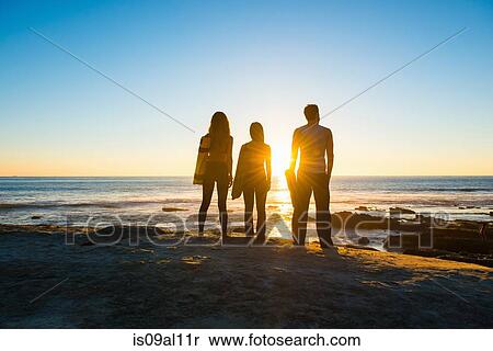 Stock Photography - Three people at Windansea beach, La Jolla, California. Fotosearch