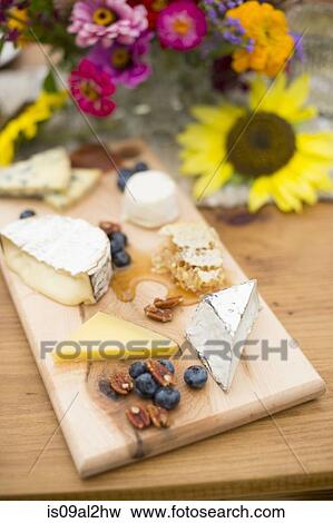 Variety of cheeses on cheese board View Large Photo Image Stock Photo - Variety of cheeses on cheese board. Fotosearch
